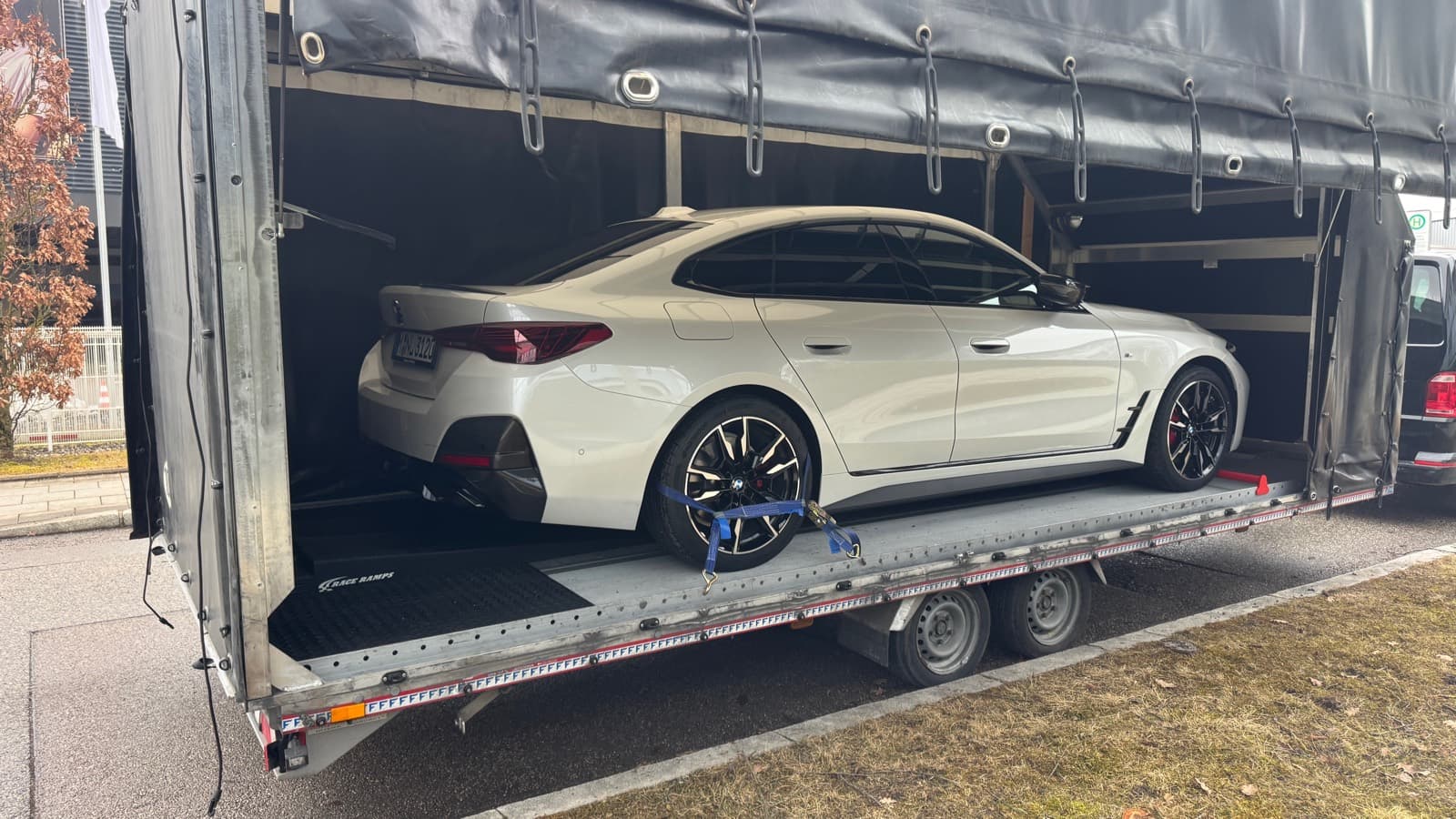 Weißer BMW auf Anhänger – diskreter Transport zum Studio